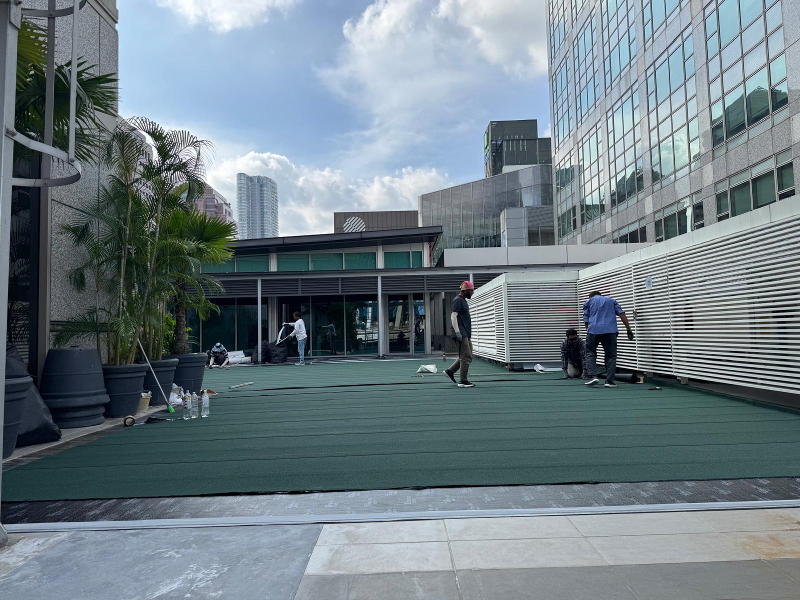 JSJ team installing NPR waterproofing on The Heeren rooftop