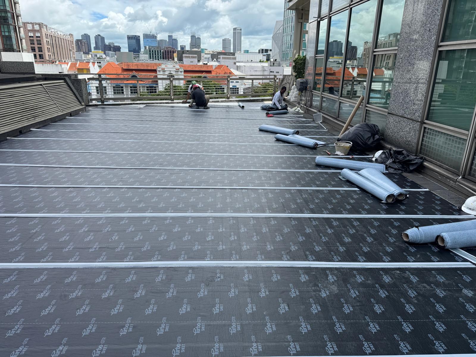 JSJ team installing NPR waterproofing on commercial rooftop in Singapore